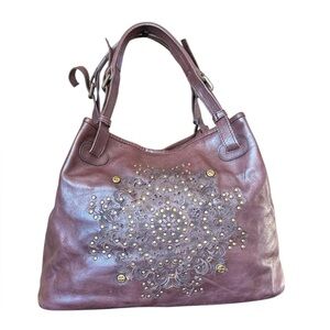 Platania Italian leather bag studded details and a laser cut-out floral design